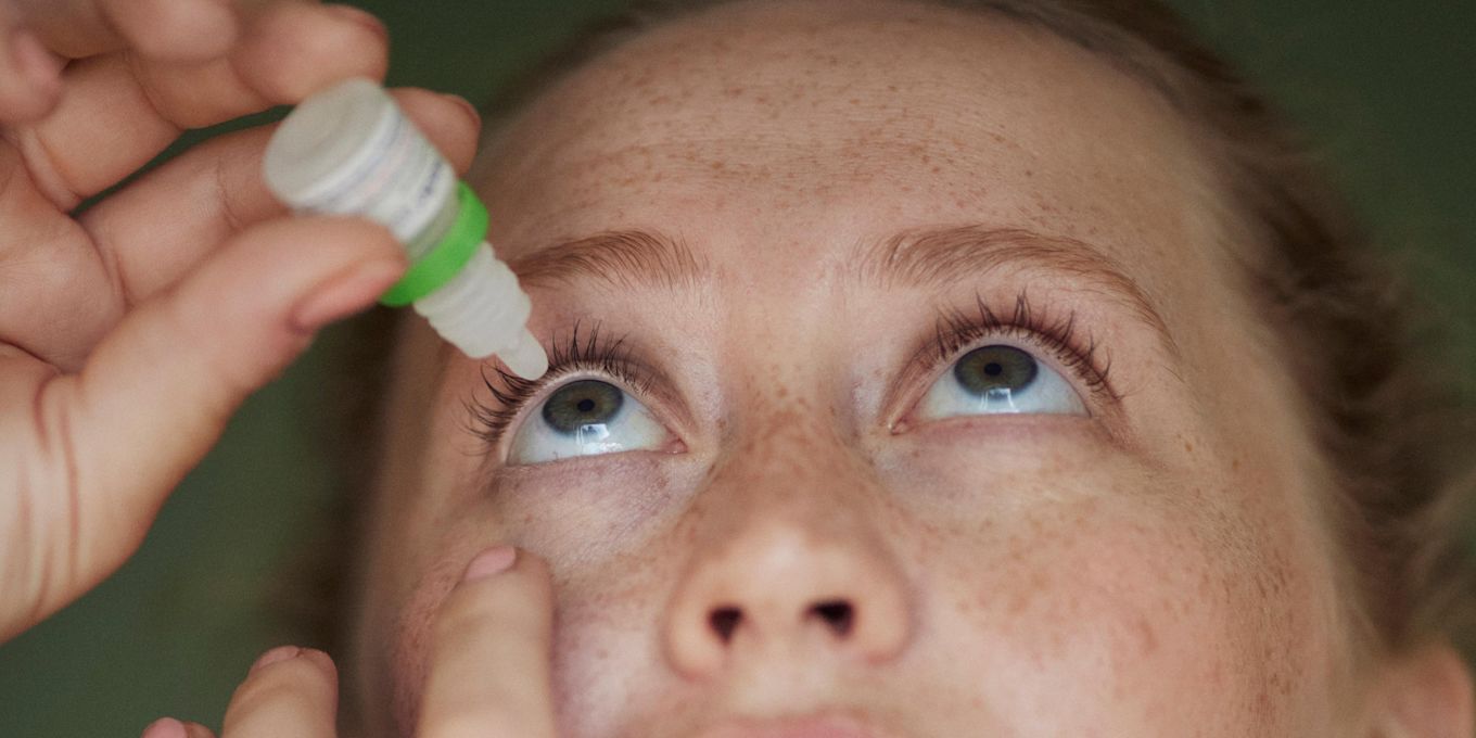 Kvinna använder ögondroppar.